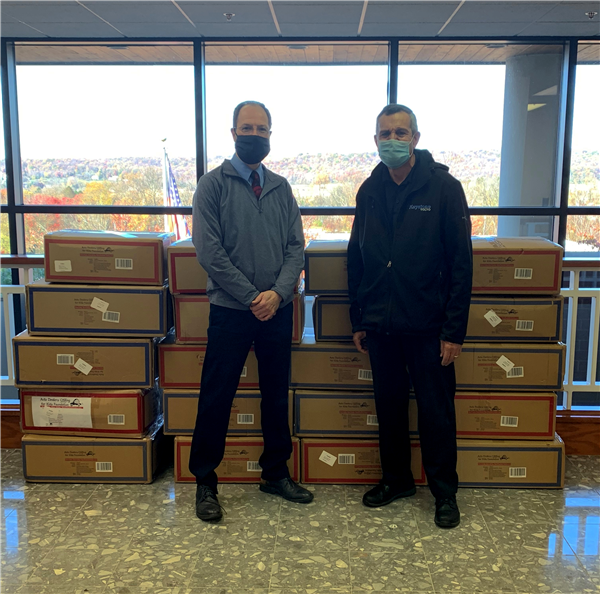 Greg Tokar and Steve Owens from Keystone Volvo Cars of Berwyn deliver boxes of coats for economically disadvantaged students  